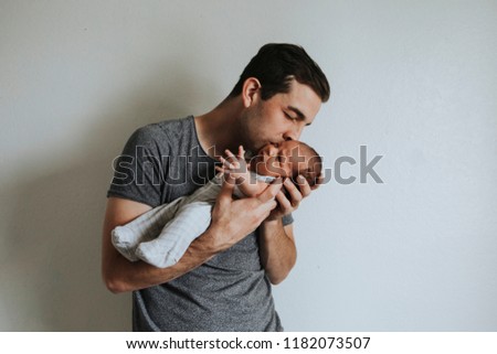 Young father holding his baby