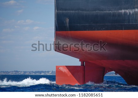 The rudder of a large ship steers it on a steady course Royalty-Free Stock Photo #1182085651