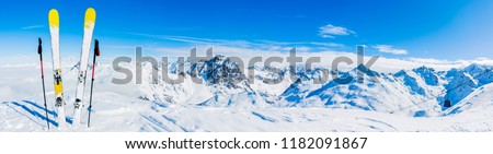 Ski in winter season, mountains and ski touring equipments on the top in sunny day in France, Alps above the clouds.
 Royalty-Free Stock Photo #1182091867