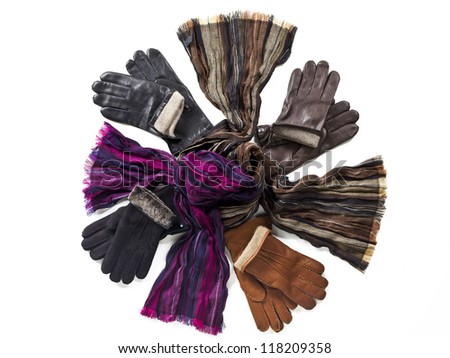 Hand gloves and scarf against white background.