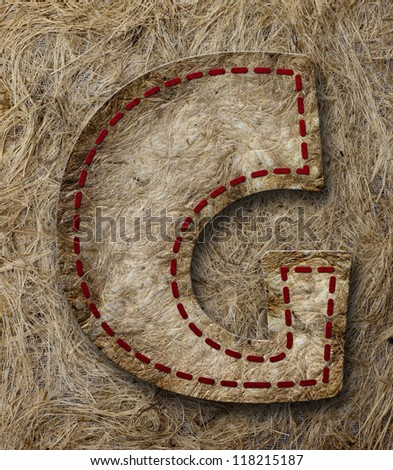 Mulberry Paper Alphabet (G) on brown paper background.