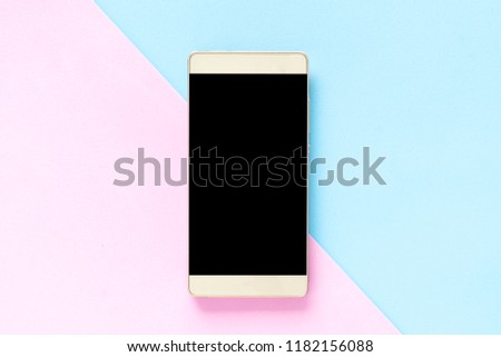 Mock up Flat lay smart phone on desk using phone black screen on top view, Background in pastel colors pink and blue