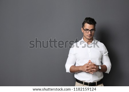 Portrait of handsome young man and space for text on black background