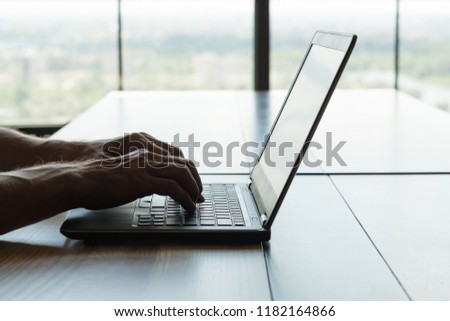 freelance work or remote job. self-employed man working on laptop. hands typing on keyboard.