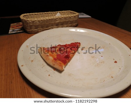 Pizza on a white plate with sausage and meat.