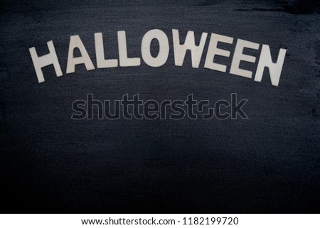 Wood letter "HALLOWEEN" on black wood background. Simple style. Holiday season. Party. Can be use for advertising, banner, brochure, web. Free space for text.