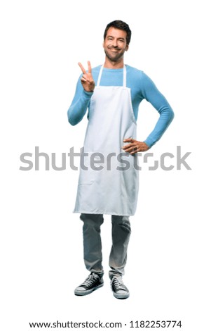 A full-length shot of a Man wearing an apron happy and counting two with fingers on isolated background