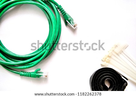 Blue and Green LAN cable with cable ties and cable strap on the white background.