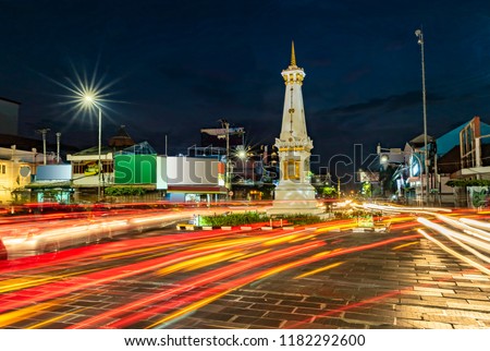 Tugu Jogja or Yogyakarta Monument, Indonesia taken in blue hours with vehicle traffic light trail blue hours Royalty-Free Stock Photo #1182292600