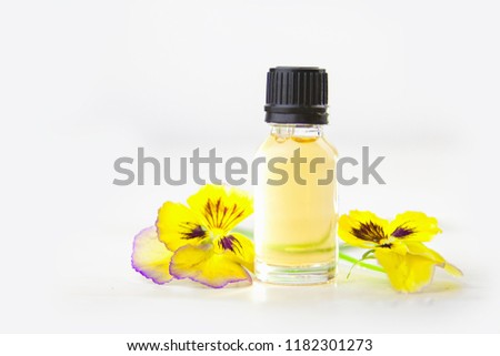 pansies essential oil in a beautiful bottle on the  White background