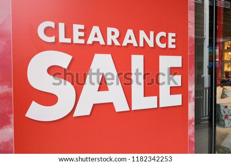 Large Clearance Sale letters on shopping mall window display, bokeh shopping mall as background.