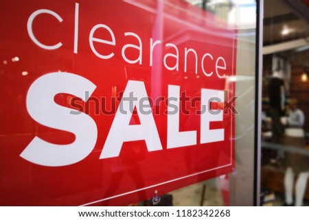 Large Clearance Sale letters on shopping mall window display, bokeh shopping mall as background.