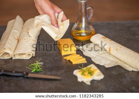 cheese, sunflower oil and thin pita bread lies on a gray stone 
