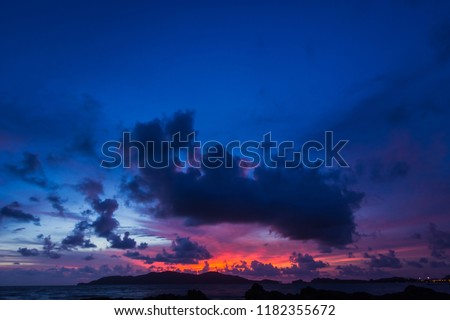Dark blue sky on Twilight in the Evening over Sea and Silhouette island,Dramatic Sunset on Nightfall,Amazing Dusk sky with sunlight nightfall,Majestic Nature Summer Backgrounds. Royalty-Free Stock Photo #1182355672