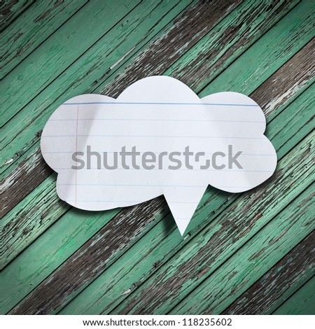 Paper speech bubble on wood background