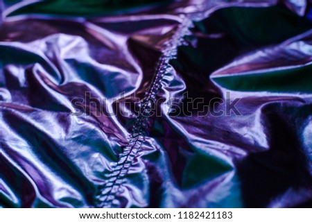 Holographic real texture in trendy colors with scratches and irregularities. Holographic color wrinkled foil. Holographic rainbow foil abstract background. 80s, 90s background. 