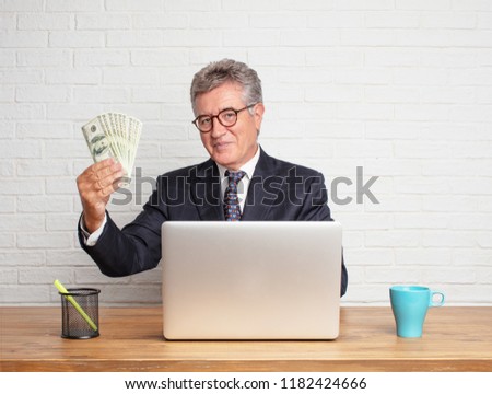 senior businessman working with his laptop. money concept