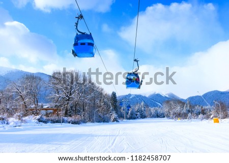 Bansko, Bulgaria winter ski resort with ski slope, lift cabins, and mountains view Royalty-Free Stock Photo #1182458707