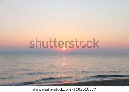 Amazing sunrise at Mediterranean sea in Greece. Colorful view at early summer morning sun.