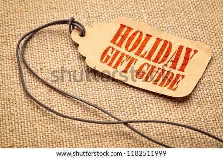 Holiday gift guide sign - a paper price tag with a twine iagainst burlap canvas
