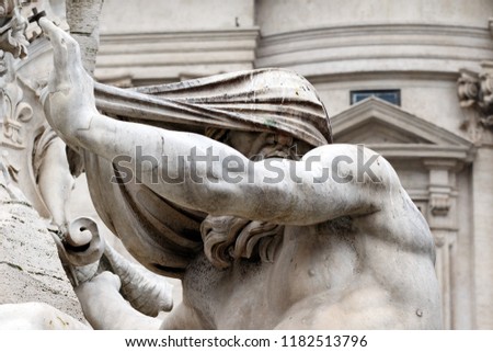 Sculpture detail of the Nile River god in The Fountain of the Four Rivers (The Fontana dei Quattro Fiumi) in the Piazza Navona in Rome, Italy.  Monument was built by Gian Lorenzo Bernini in 1651. Royalty-Free Stock Photo #1182513796