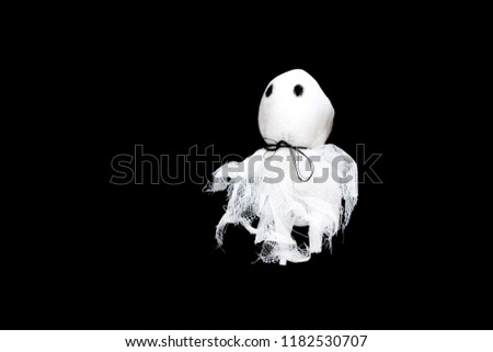 Close up white symbol of Halloween. Ghost isolated on black background.