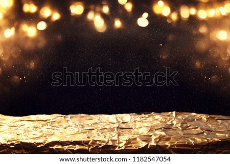 glitter vintage lights background. black and gold. de-focused, golden foil texture