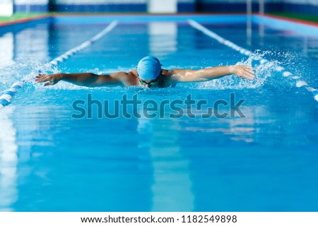 Image of sportsman swimming along path in pool