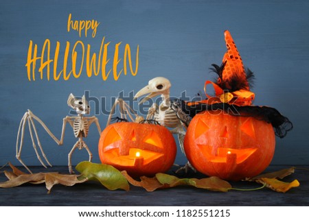 Halloween holiday concept. Pumpkins over wooden table