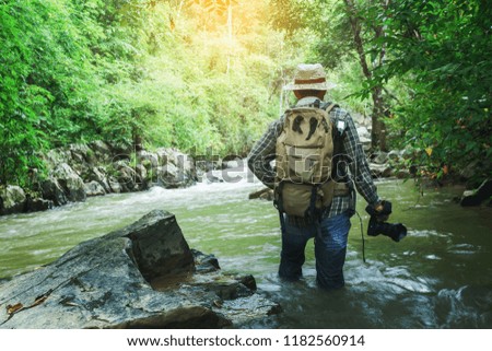 Nature photographer will take photos calm water stream around the rocks in forest