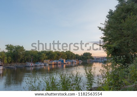 Twilight image of Mississippi River from Raspberry Island. sunset with house boats, tree lined smooth river scene