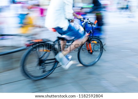 bicycle rider in the city in camera made motion blur