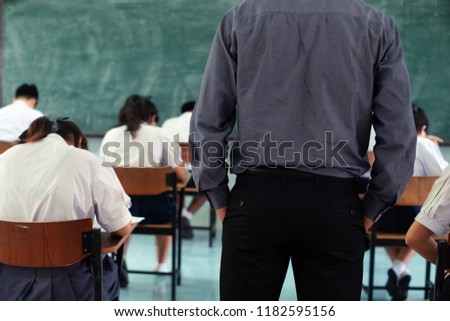 Teachers stand strict test or exam. Royalty-Free Stock Photo #1182595156