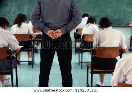 Teachers stand strict test or exam. Royalty-Free Stock Photo #1182595165