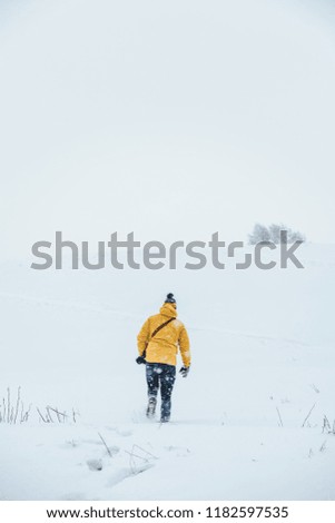 Traveling in winter, man photographer hiking in winter time