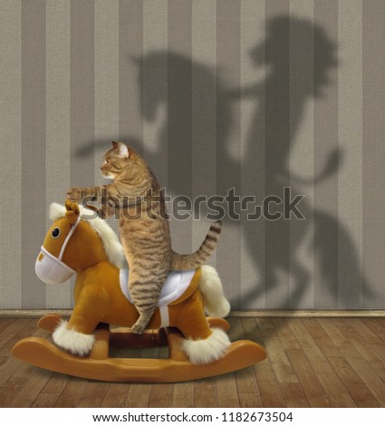 The cat on the a soft toy rocking horsecasts the strange shadow on a wall of the room.