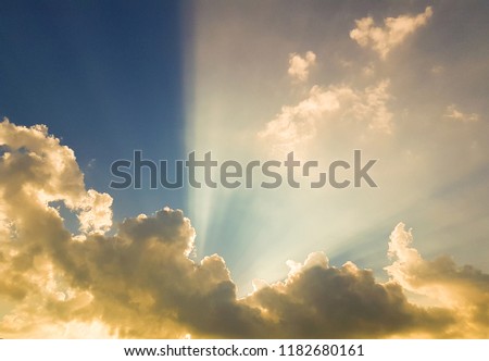 Sun rays at sunset caused by rain clouds