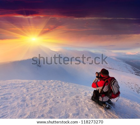 Photographer takes a sunset in the mountains