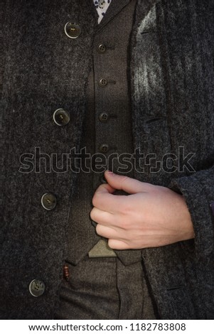 A man in a gray woolen sweater