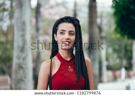 Portrait of beautiful happy black woman with braided hair.