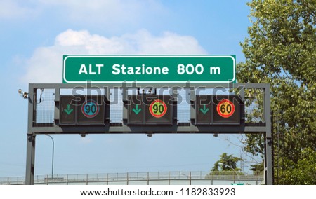 Big Italian road signs on the highway. The text means STOP Station at 800 meters and you must pays