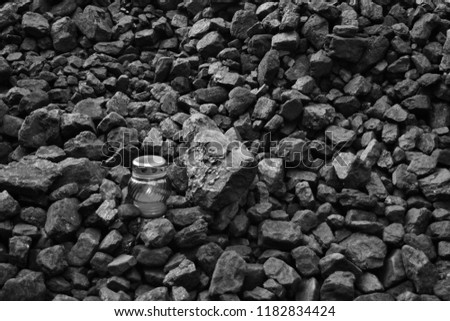 Vigil light, candle on heap of coal after the fatal accident in the mine, black and white photo