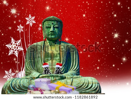 christmas card buddha monk statue with presents holding 2 small christmas trees with hats and a red christmas background with stars