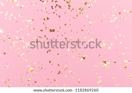 Golden sparkles on pink pastel trendy background. Festive backdrop for your projects. Royalty-Free Stock Photo #1182869260