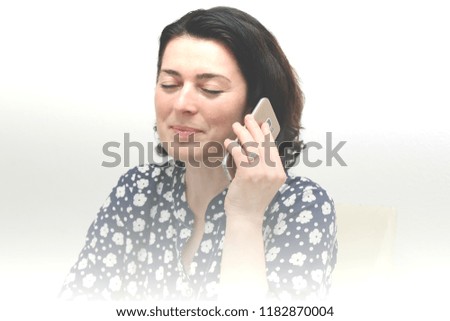 Young business woman with mobile phone in the office