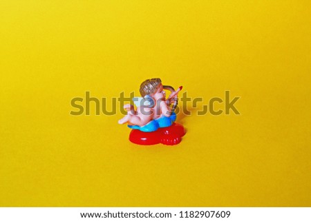 Colorful cupid figure on yellow background