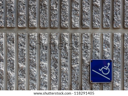 Ramp Access Sign for the Disabled on Concrete Wall