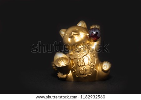 golden cat in a black background Royalty-Free Stock Photo #1182932560