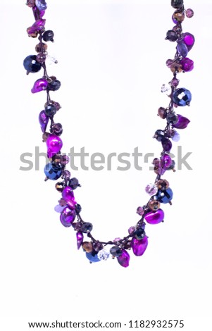 purple necklace in a white background Royalty-Free Stock Photo #1182932575