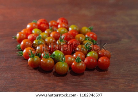 fresh mini tomatoes on a wood table